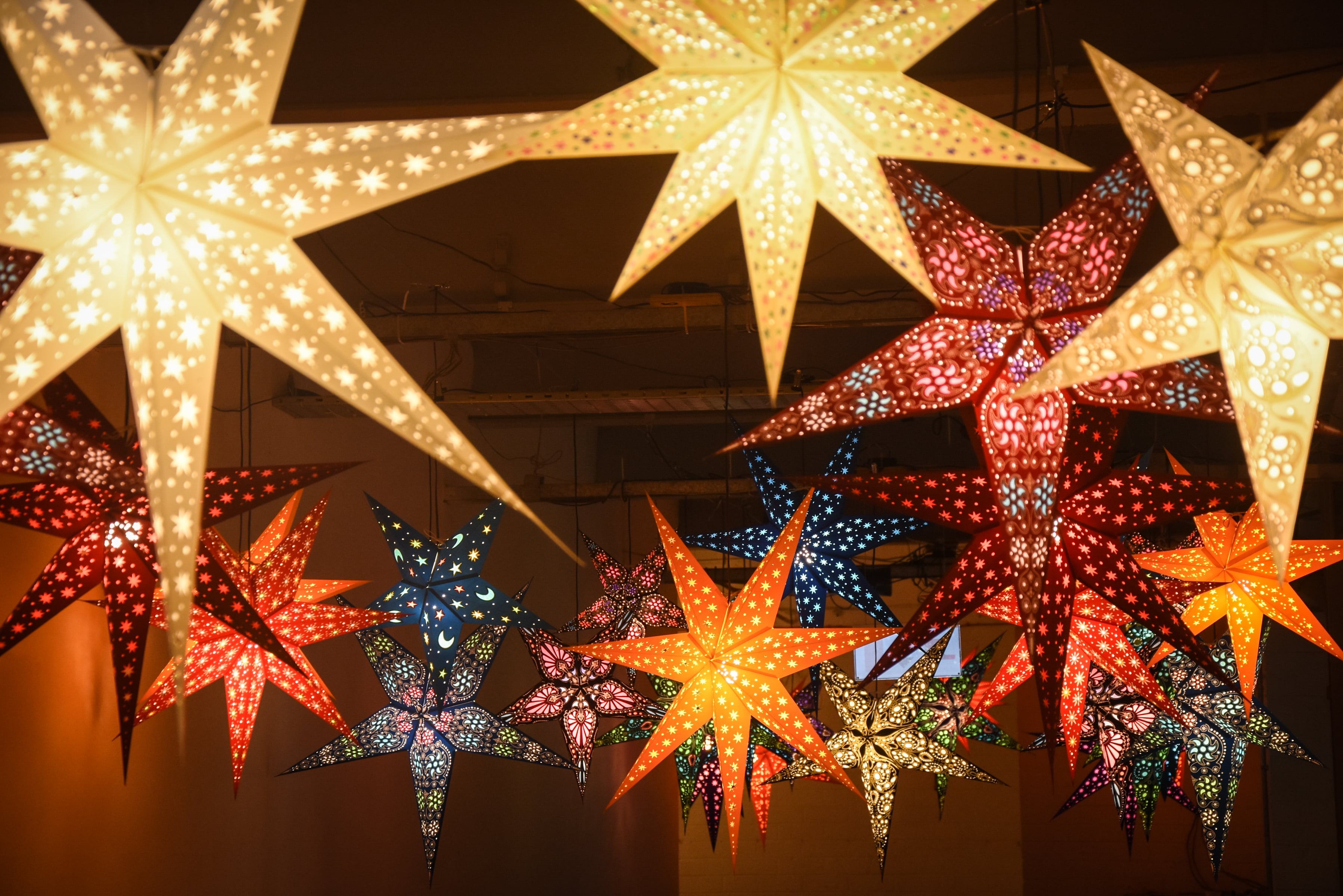 many colourful stars hanging from the ceiling