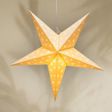 Star-shaped lantern with a warm glow on a beige background
