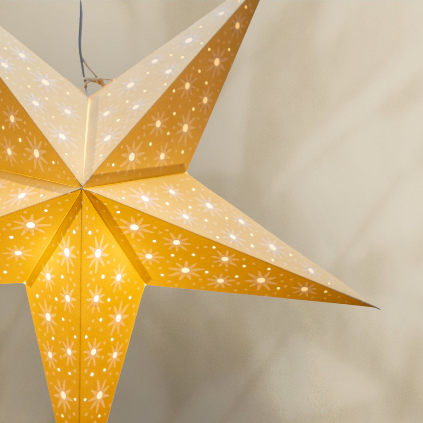 Star-shaped lantern with LED lights on a neutral background
