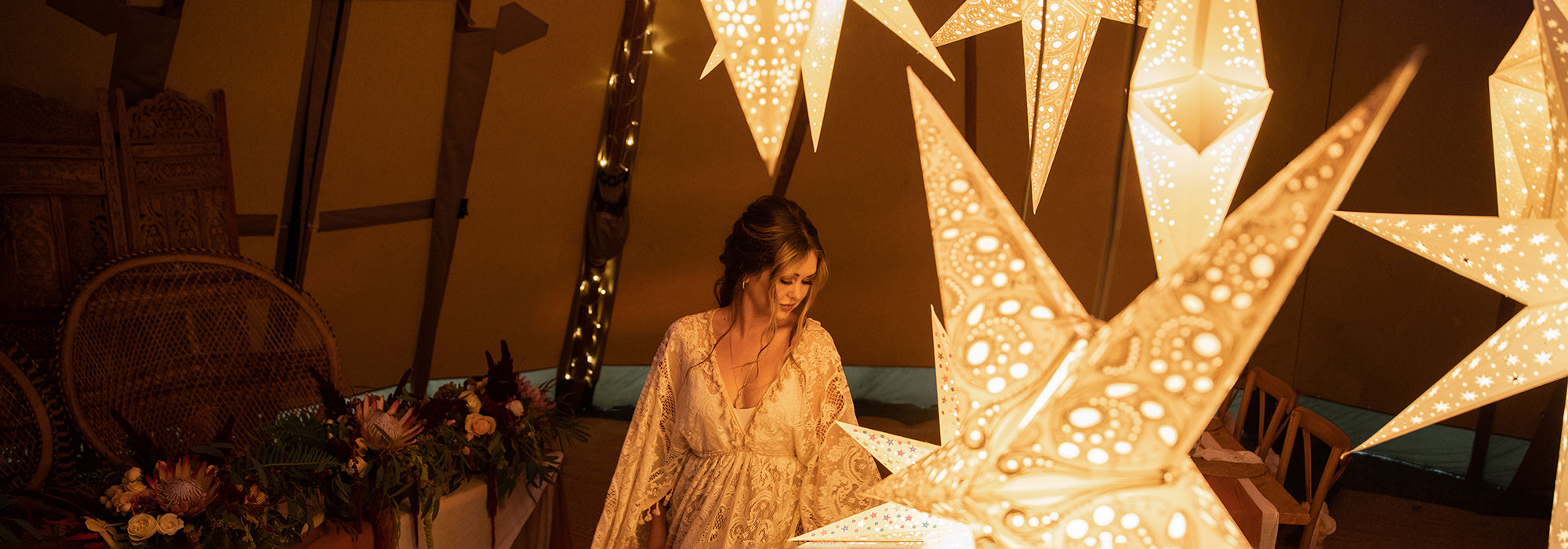 Bride in a tipi under paper star lanterns