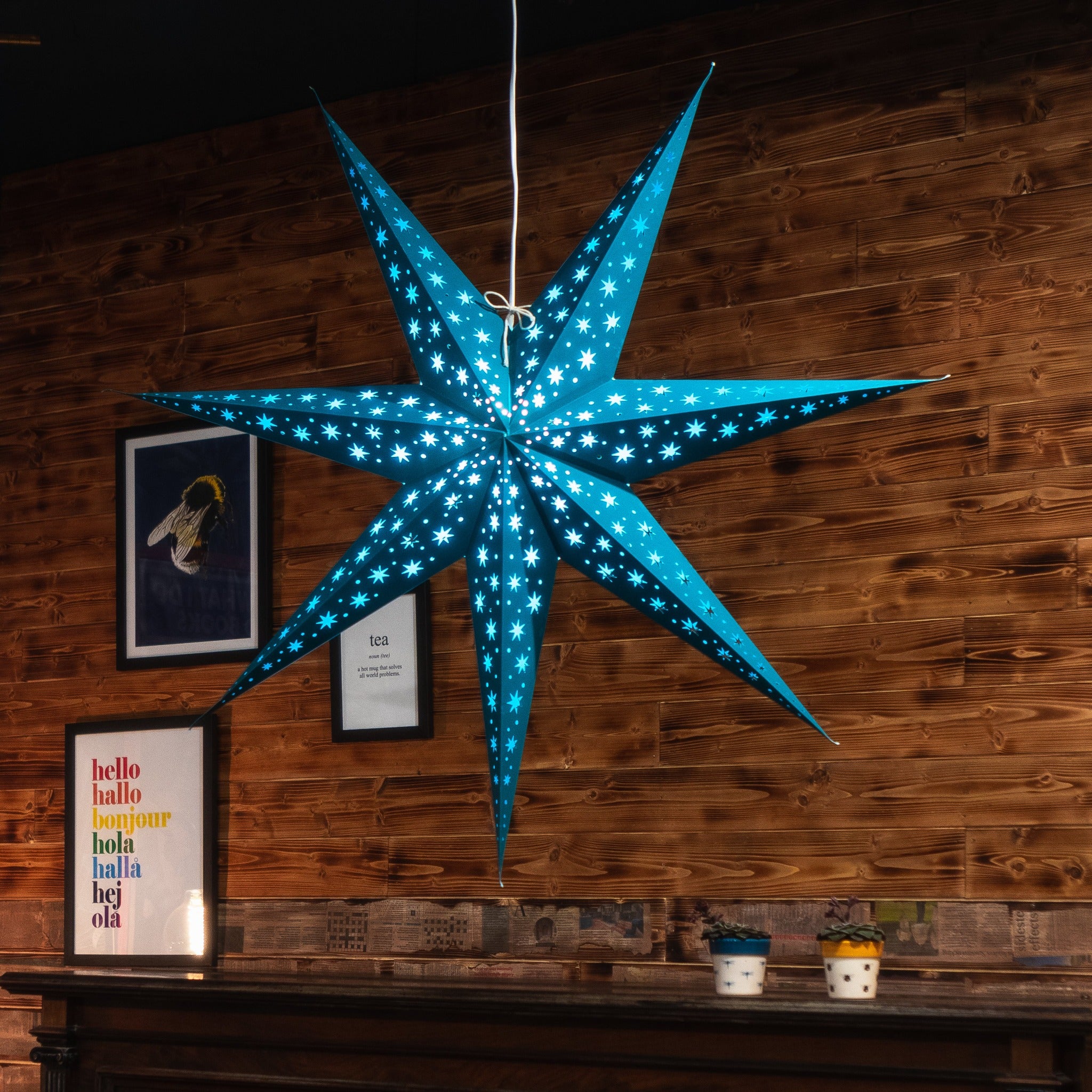 teal paper star lantern illuminated