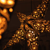 close up of large black and white star lantern