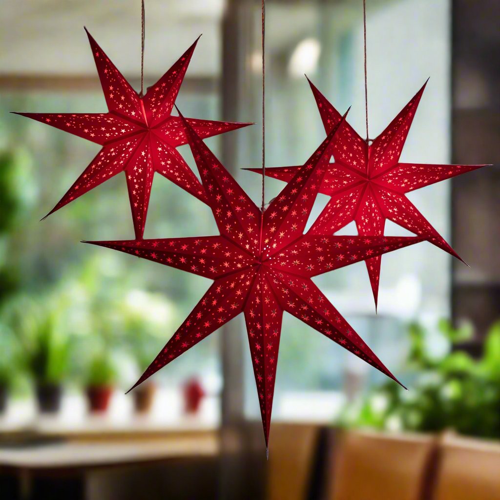 3 red star lanterns illuminated