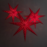 3 red star lanterns illuminated