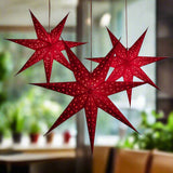 3 red star lanterns illuminated