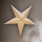 Star-shaped decorative light hanging against a neutral background