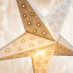 Star-shaped lamp with geometric pattern on a neutral background