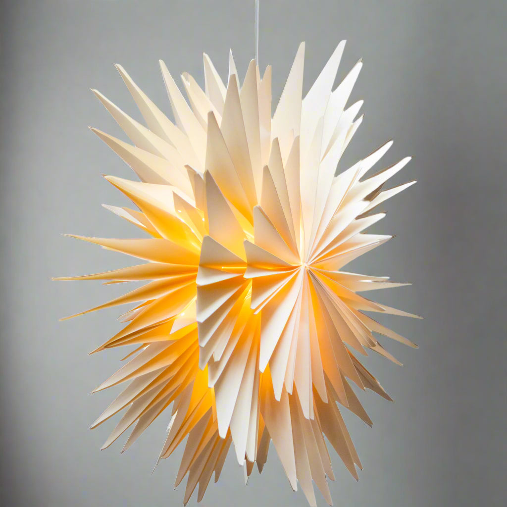 Star-shaped pendant light with a warm glow on a white background