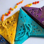 Set of 8 Colourful mini paper stars in red, yellow, blues and purples, perfect for holiday ornaments or year-round home decor accents.