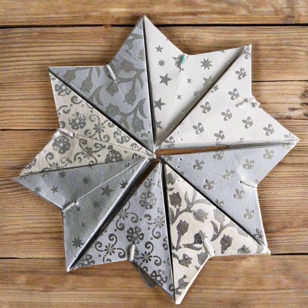 Set of 8 white mini stars in neutral and silver tones, perfect for holiday ornaments or year-round home decor accents.