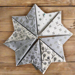 Set of 8 white mini stars in neutral and silver tones, perfect for holiday ornaments or year-round home decor accents.