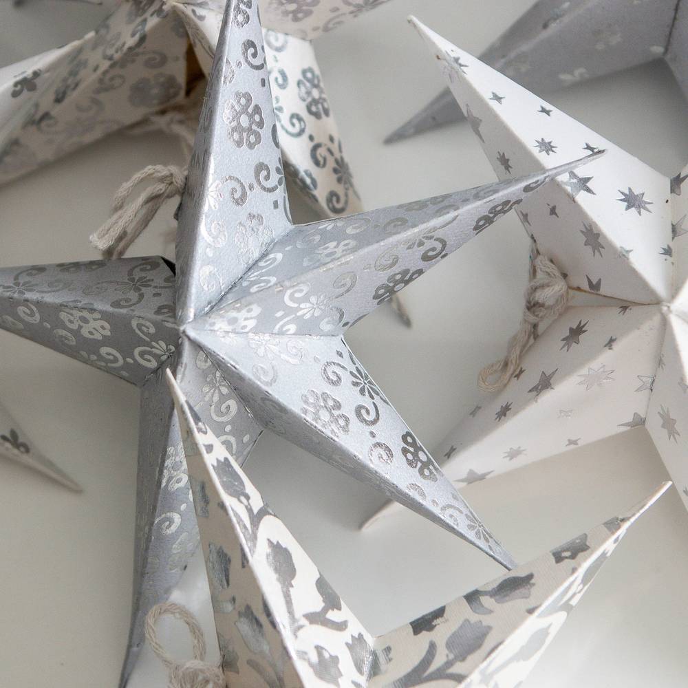 Set of 8 white mini stars in neutral and silver tones, perfect for holiday ornaments or year-round home decor accents.