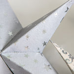 Set of 8 white mini stars in neutral and silver tones, perfect for holiday ornaments or year-round home decor accents.