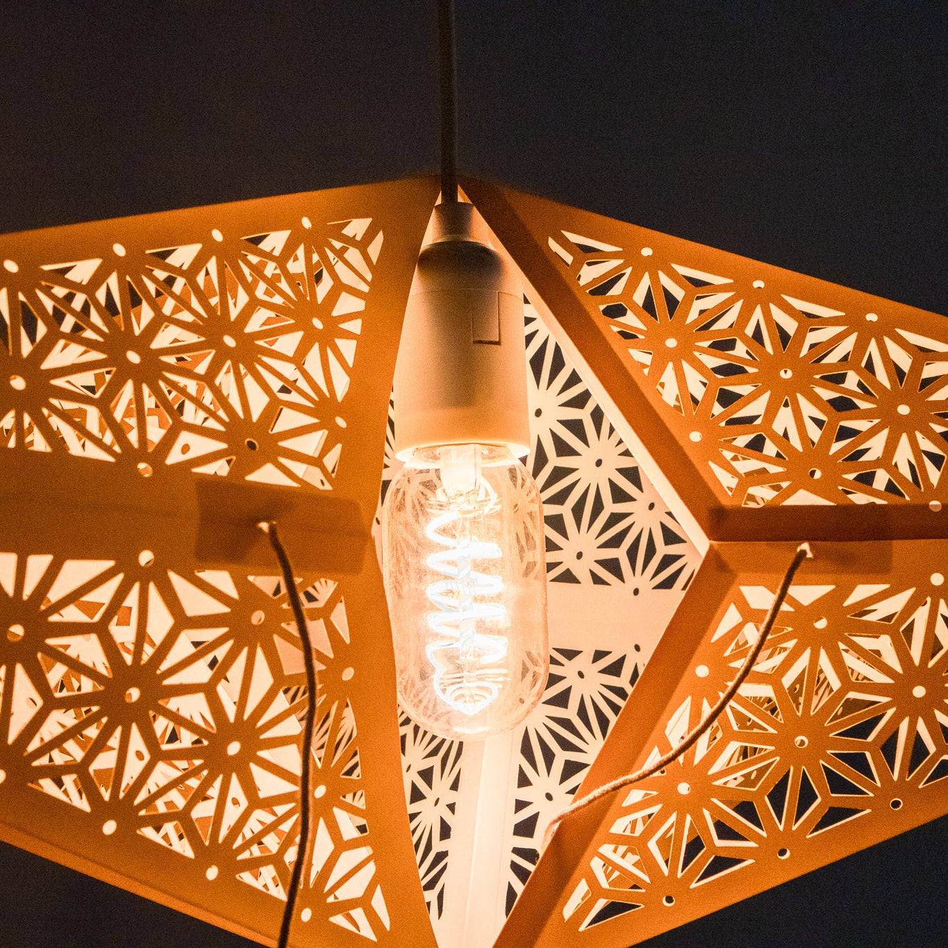 Close-up of Tiffany: Yellow paper star lantern lit from inside