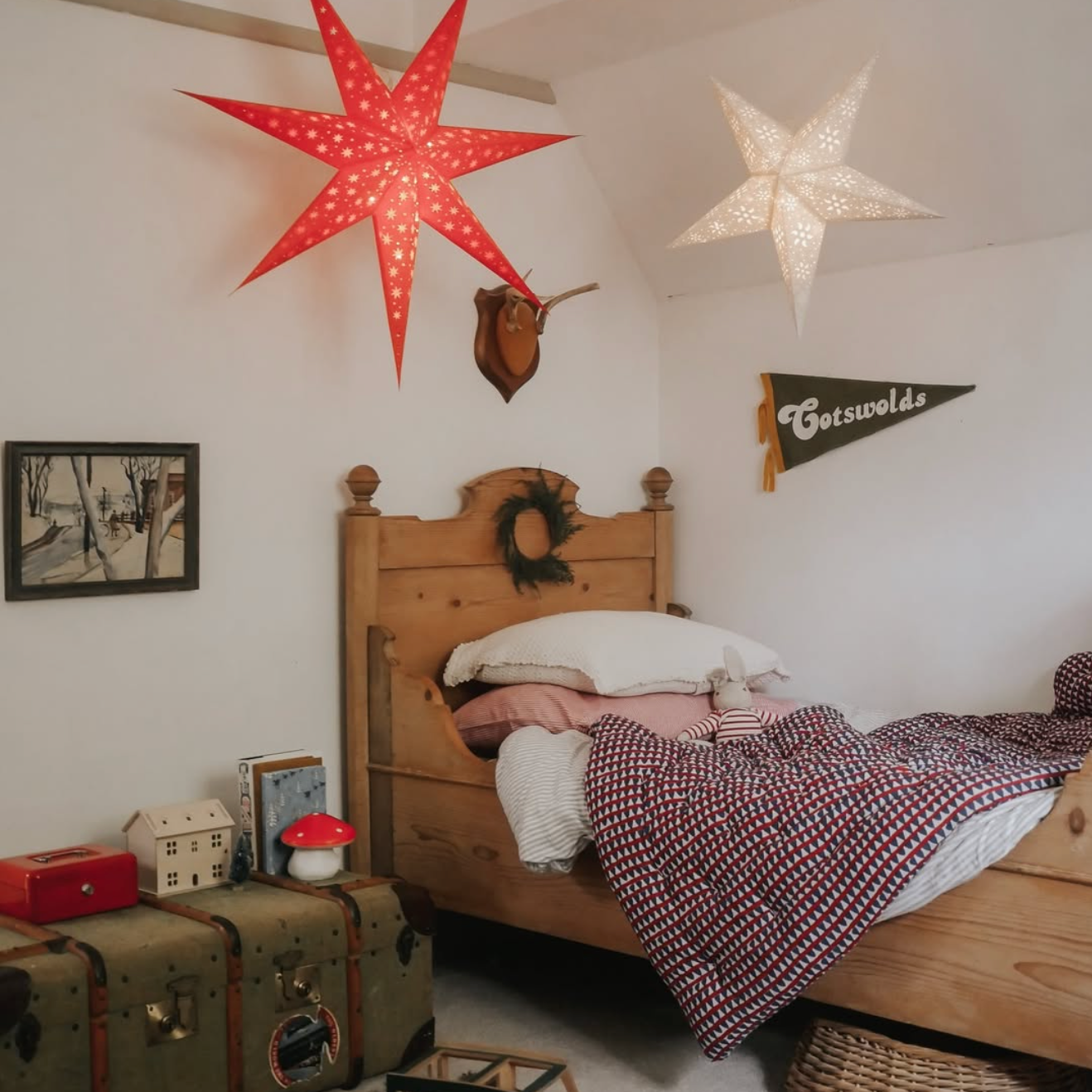 Children's bedroom with wooden bed, star-shaped lights, and vintage decor.