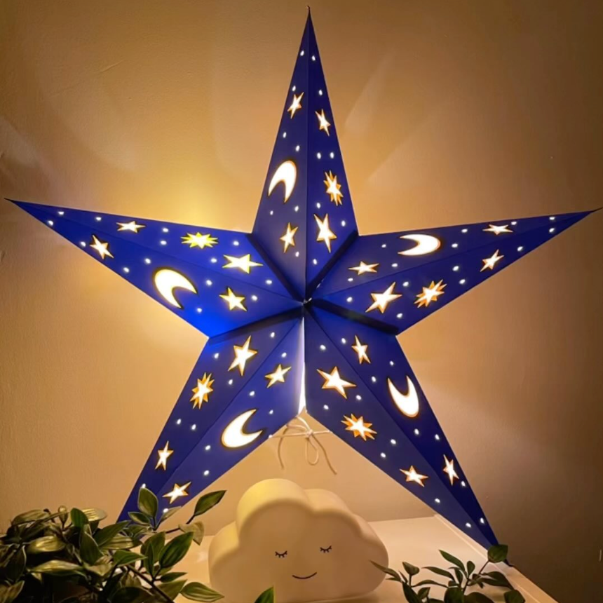 Blue star-shaped lamp with star and moon patterns on a neutral background