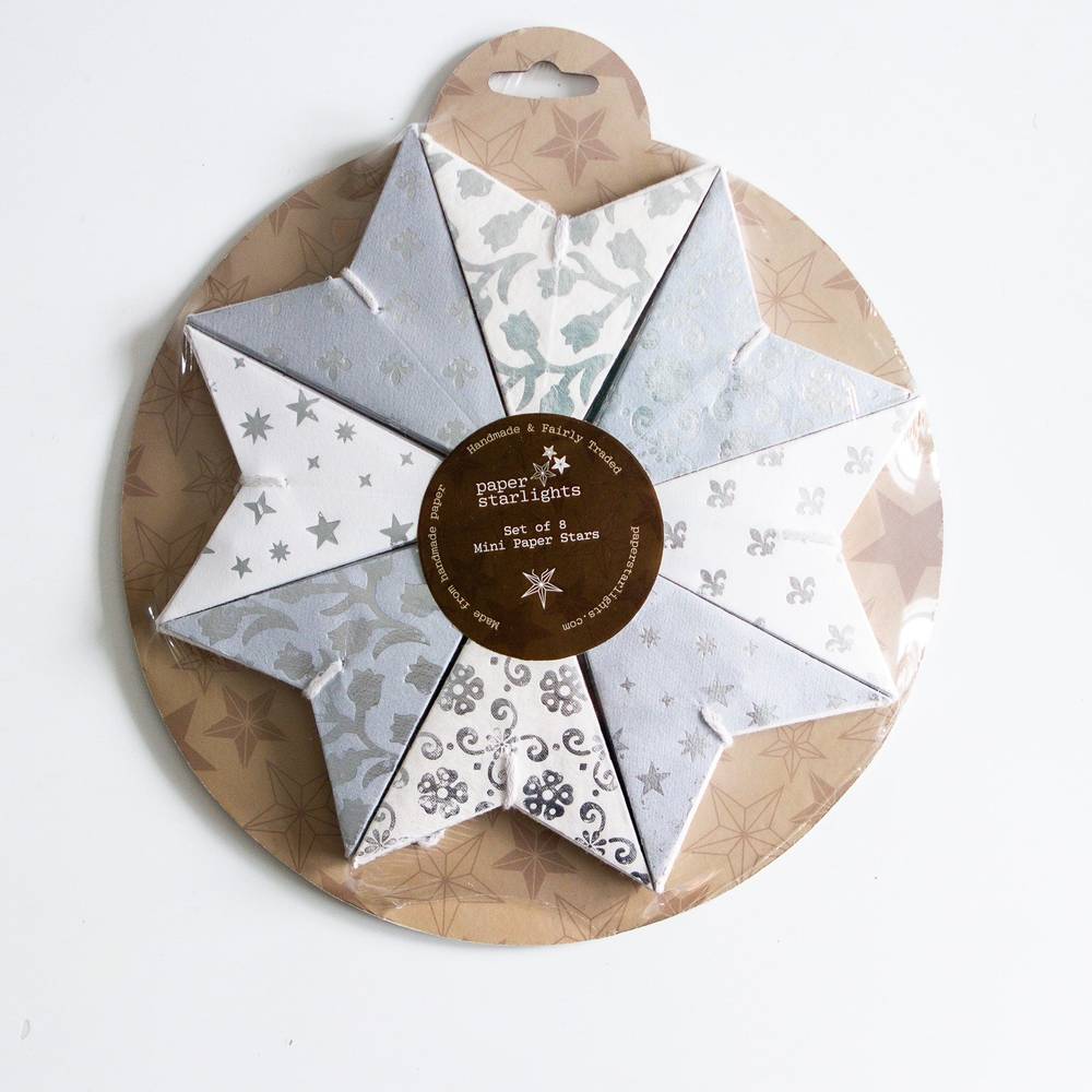 Set of 8 white mini paper stars in neutral and silver tones, perfect for holiday ornaments or year-round home decor accents.