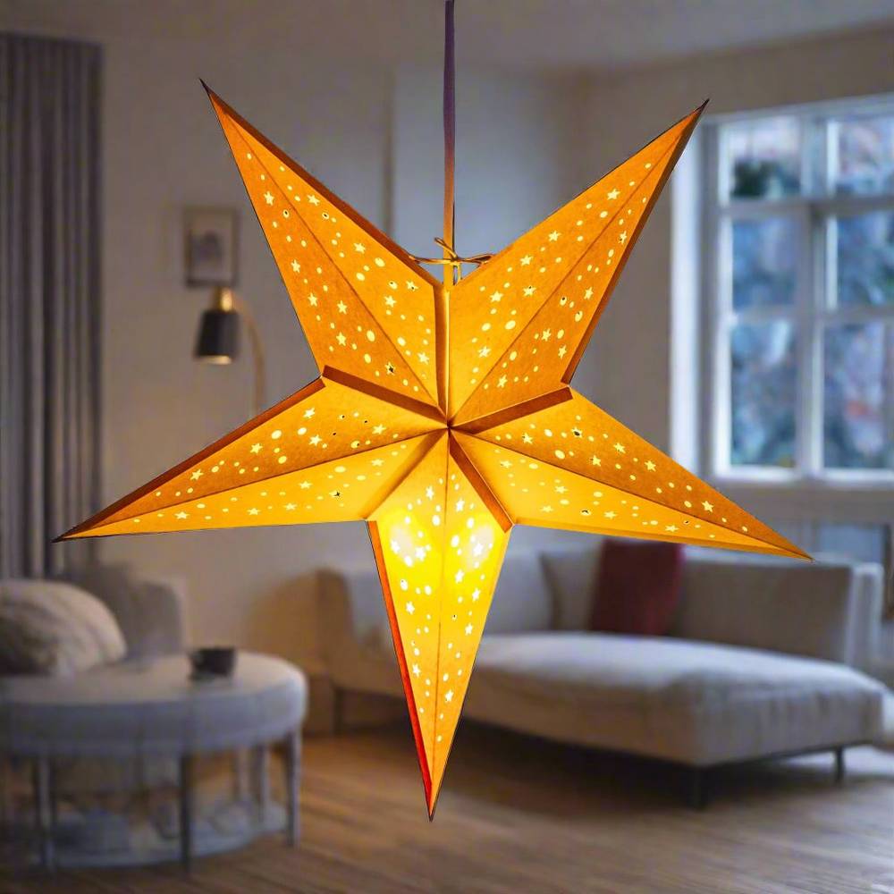 Baby Starry Yellow handmade paper lantern in star shape, glowing warmly in a cosy living room. Eco-friendly lighting for home decor, 42cm diameter.