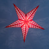 Tiffany: Red paper star lantern with warm glowing cutouts