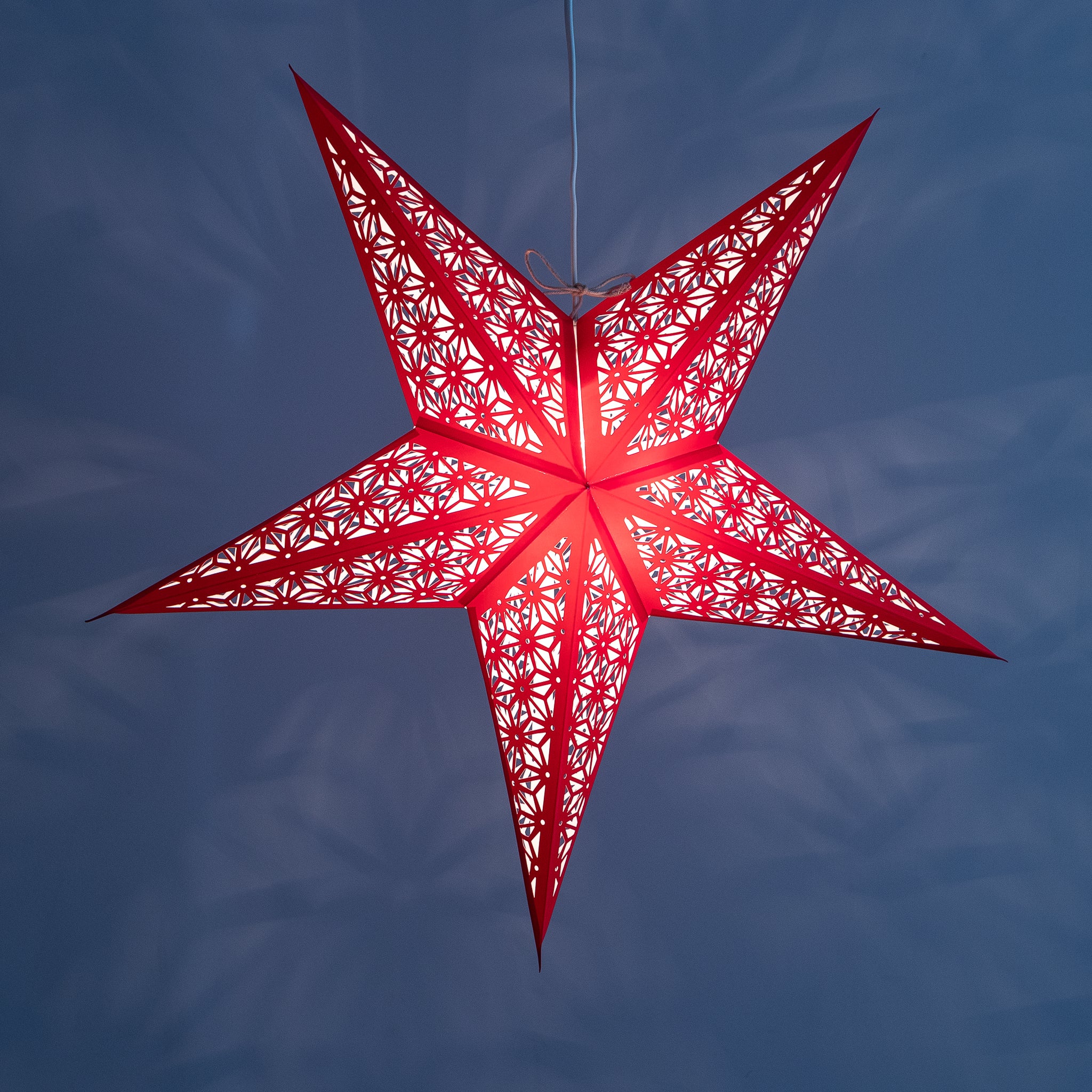 Tiffany: Red paper star lantern with warm glowing cutouts