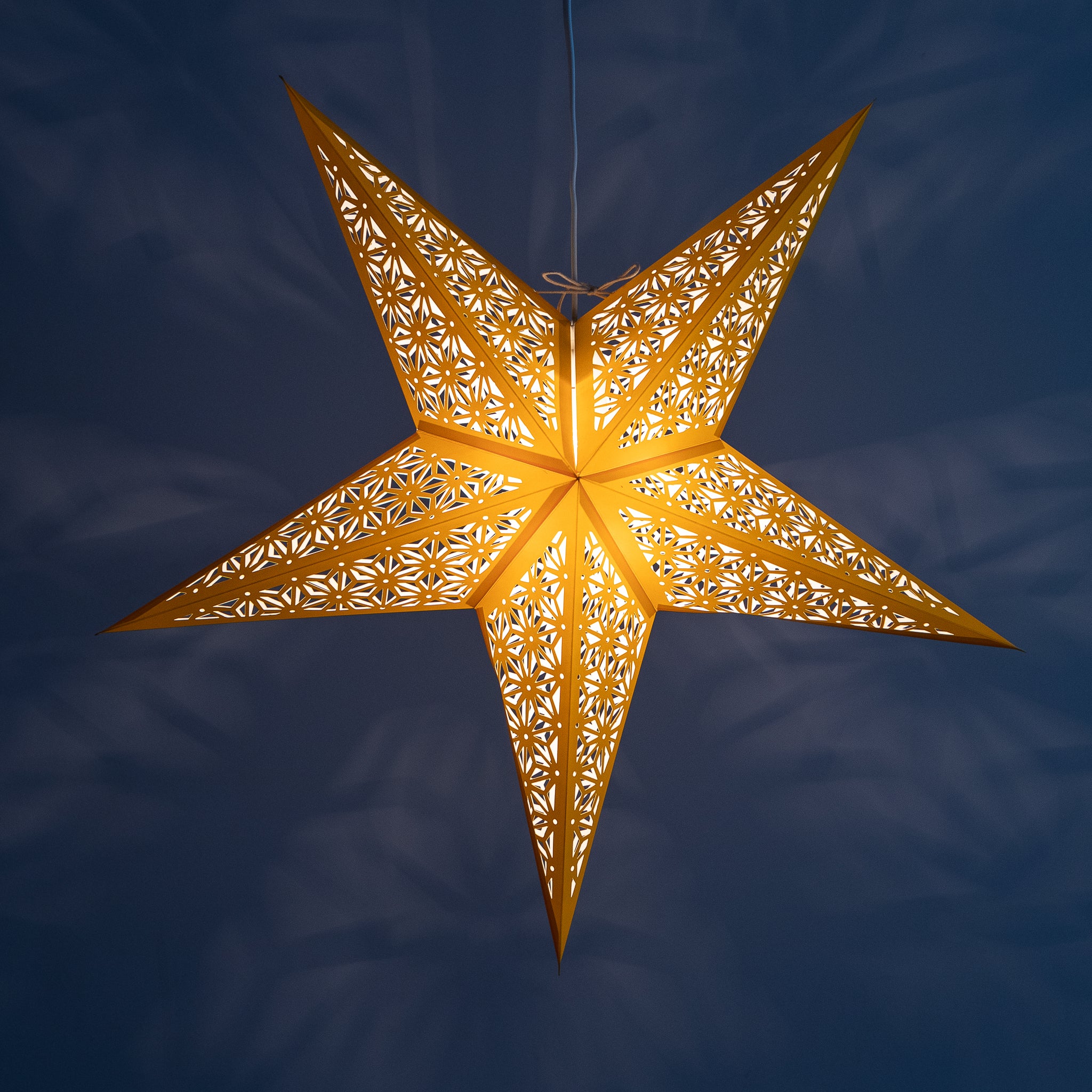 Tiffany: Yellow paper star lantern with warm glowing cutouts
