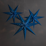 3 blue paper star lanterns illuminated