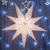 white sequinned paper star lantern