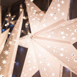 three white paper star lanterns